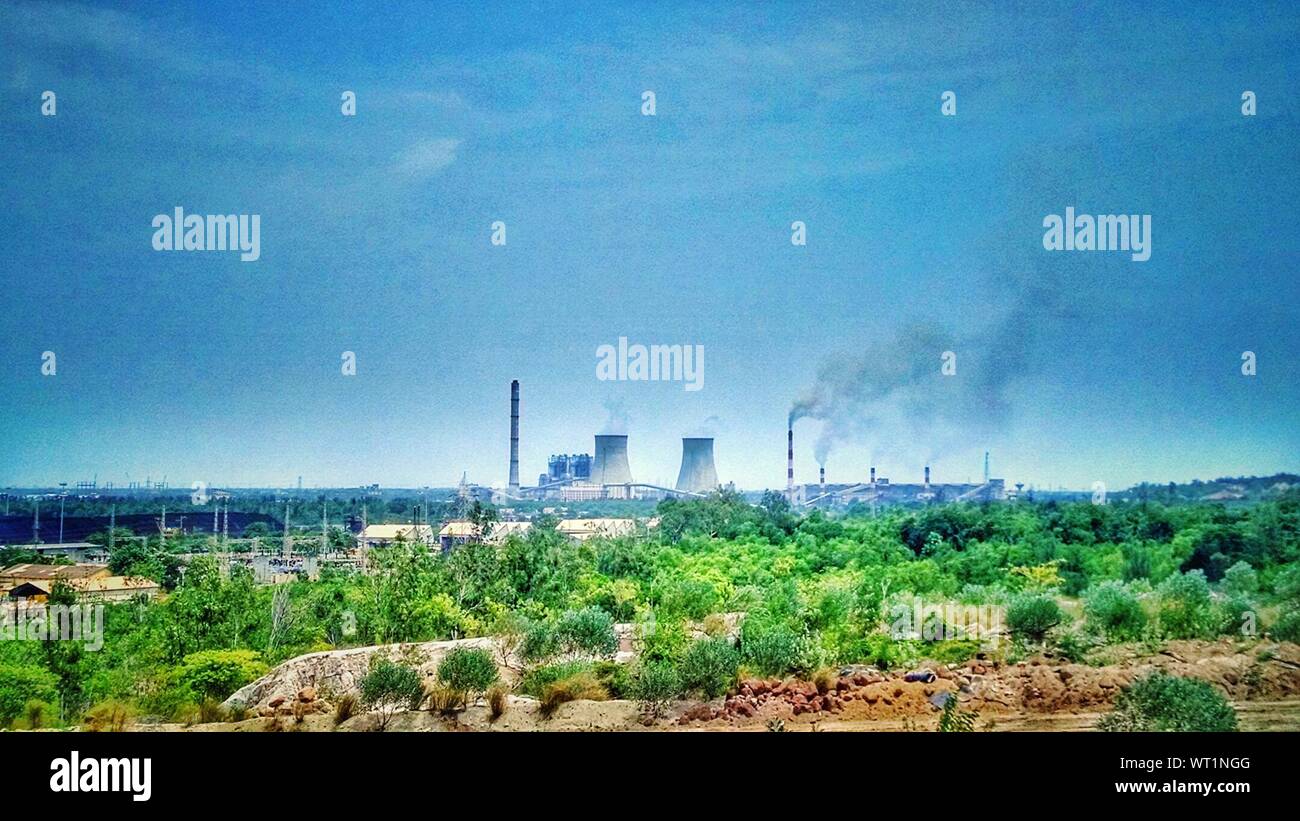 View Of Power Station Emitting Smoke Stock Photo