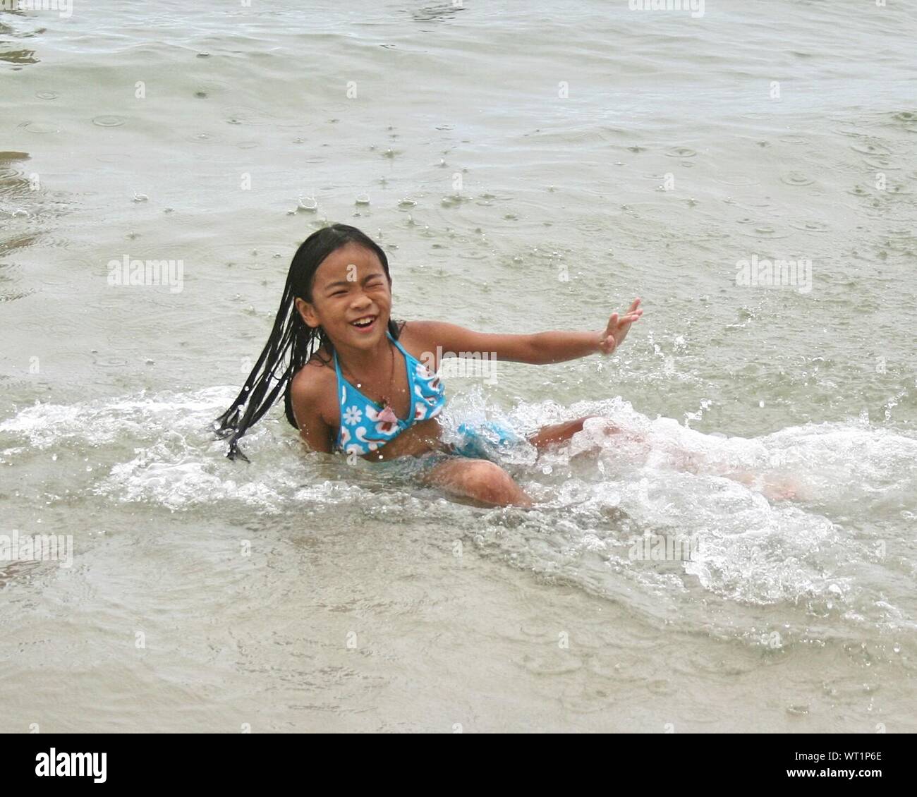 Cheerful Teenage Girl Playing In Sea Stock Photo