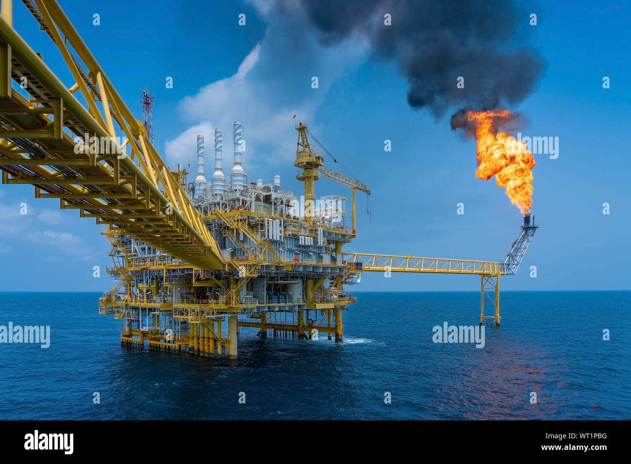 Offshore oil and gas construction platform while vent gases to flare platform to prevent over pressure from process upset, Power and energy business i Stock Photo