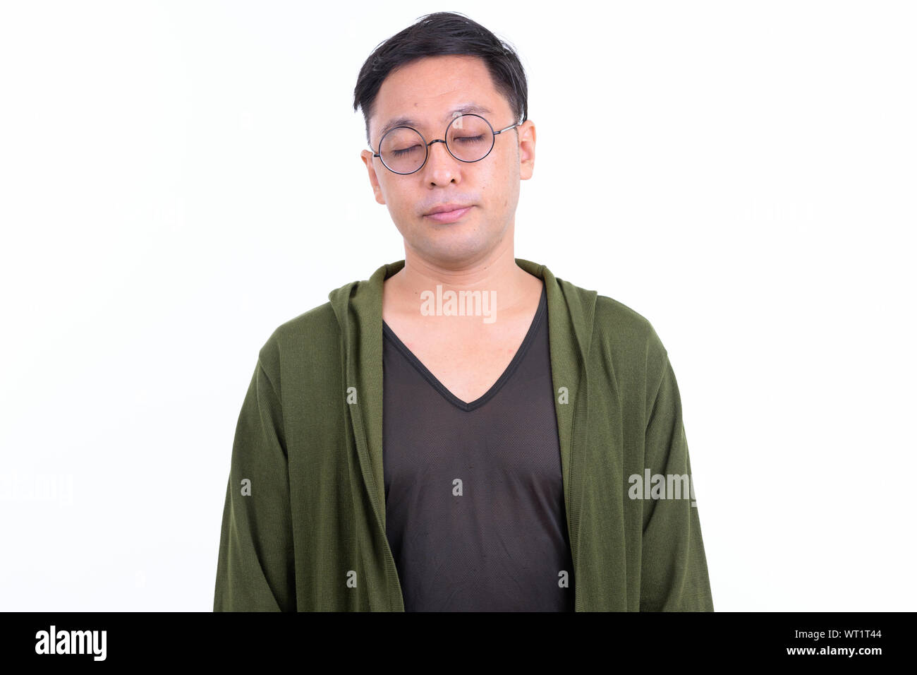 Japanese man wearing eyeglasses relaxing with eyes closed Stock Photo