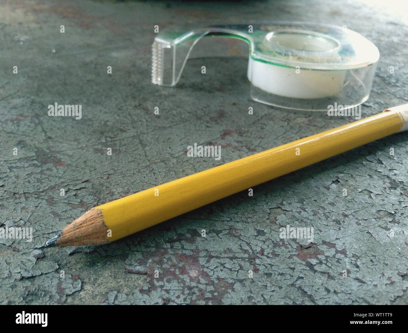 Close-up Of Pencil With Adhesive Tape On Table Stock Photo