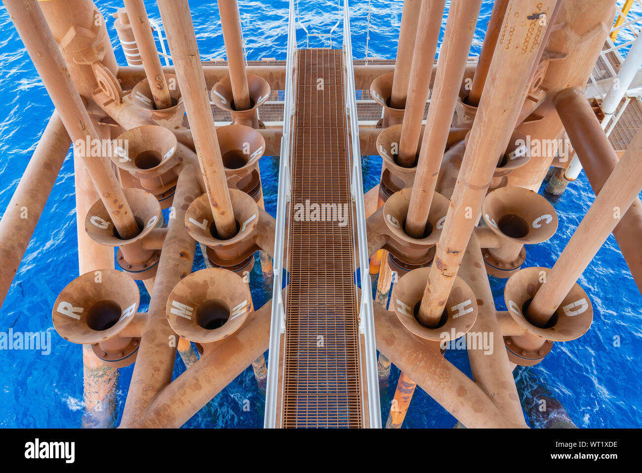 Production casing and tubing in offshore oil and gas platform structure which produced raw gases and crude from sub surface to surface facility. Stock Photo