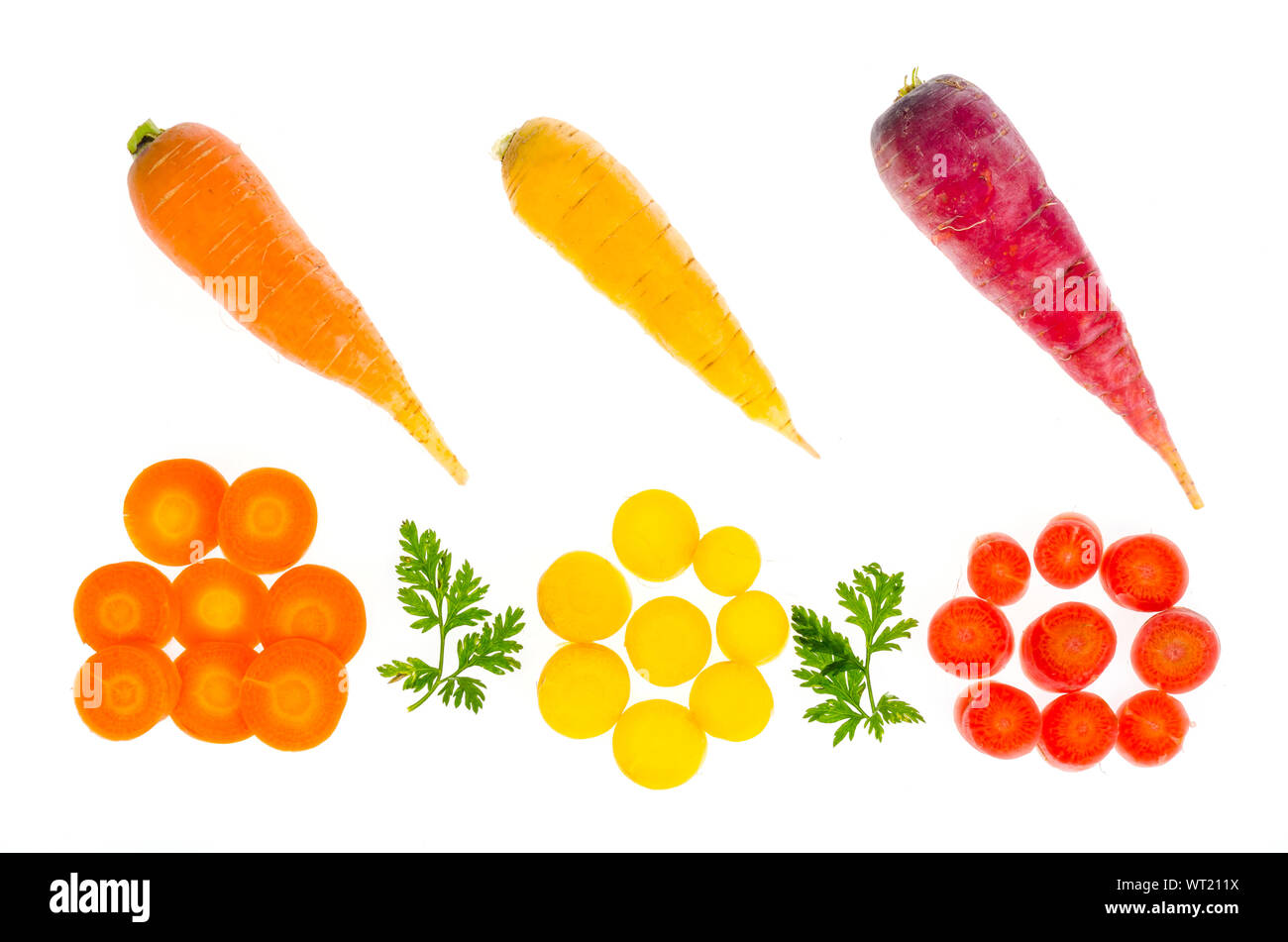 Pieces of colorful raw carrots on white background. Studio Photo Stock