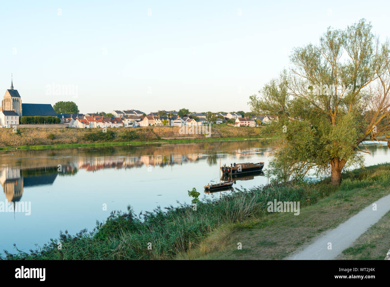 Horizontal view of the smalltown of Jargeau in the French countryside on the Loire river with riverboats in the foreground Stock Photo