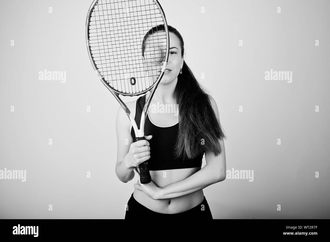 Beautiful Young Woman In Sports Clothing Holding Tennis Racket On
