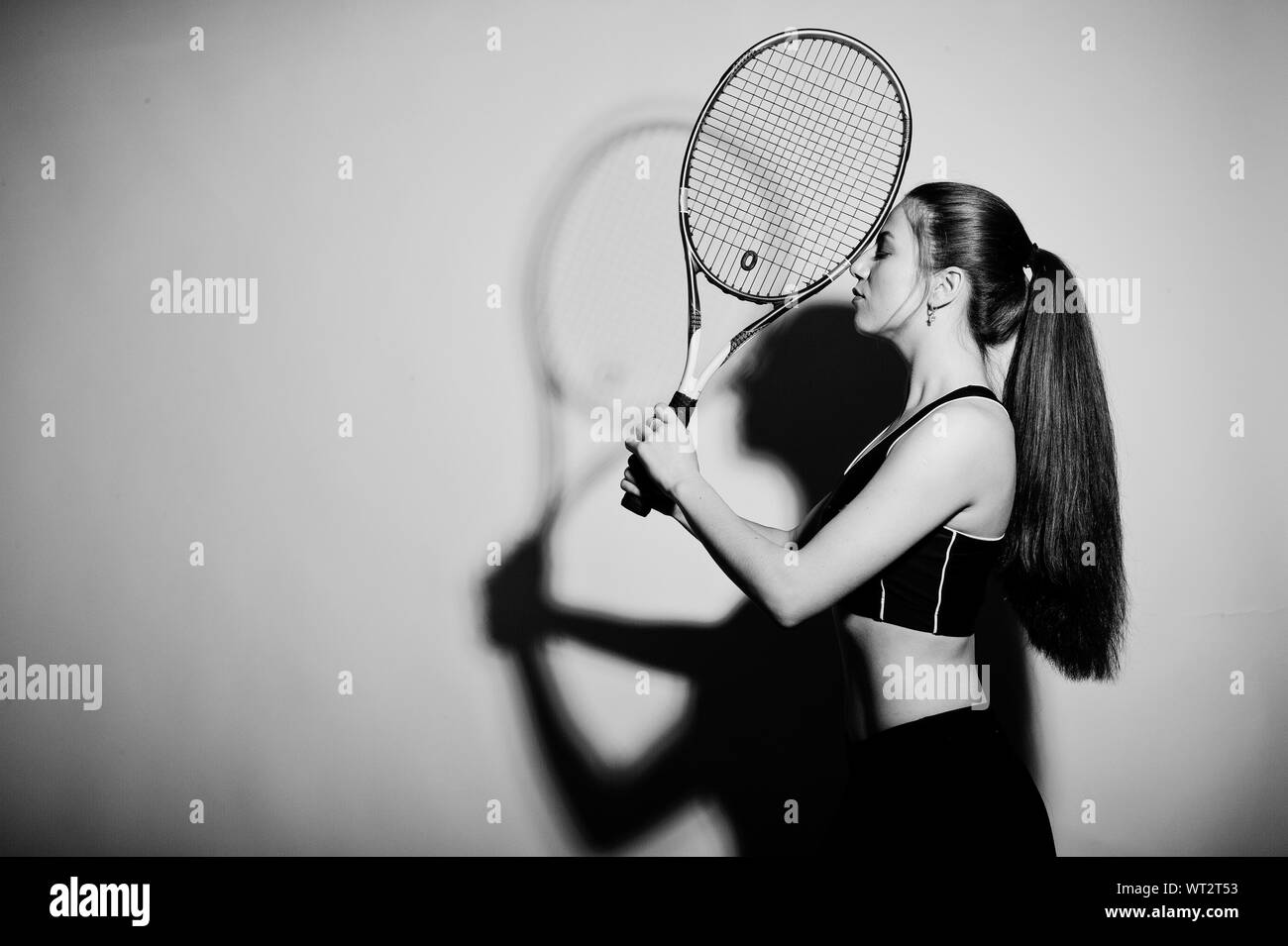 Black and white portrait of beautiful young woman player in sports ...