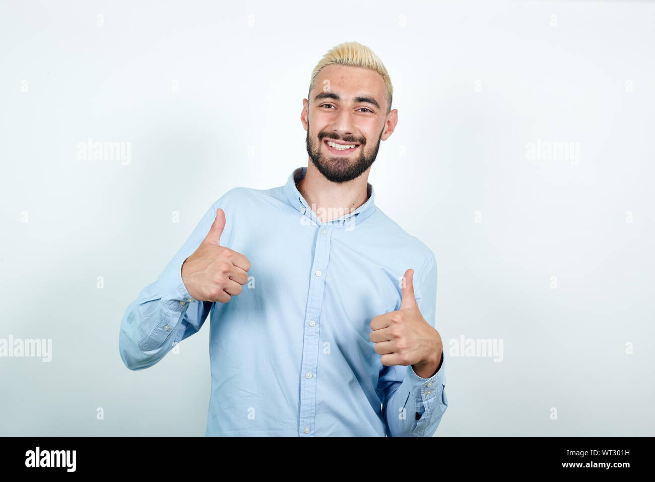 man with blond hair, black beard over isolated white background shows emotions Stock Photo