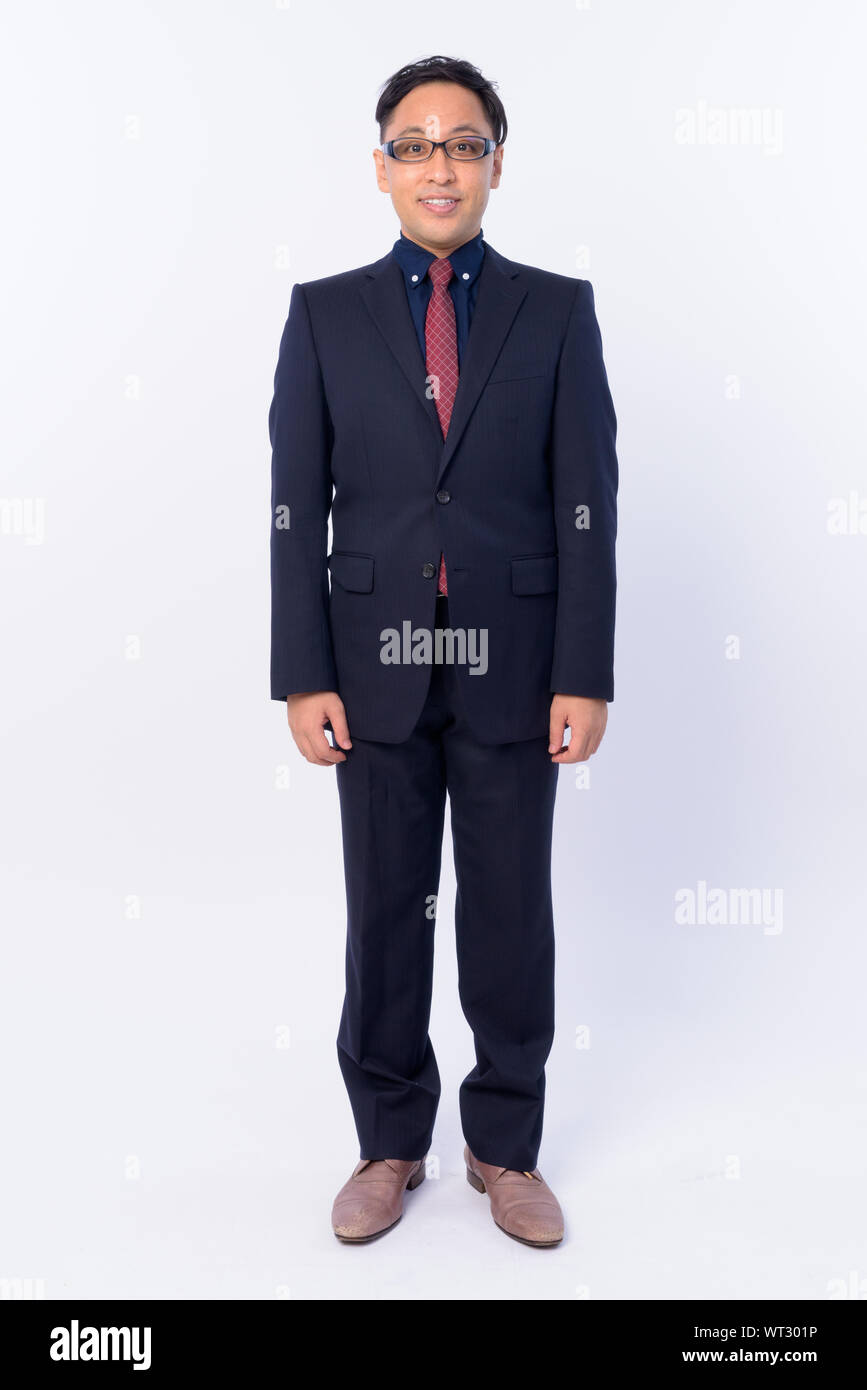 Full body shot of happy Japanese businessman in suit smiling Stock ...