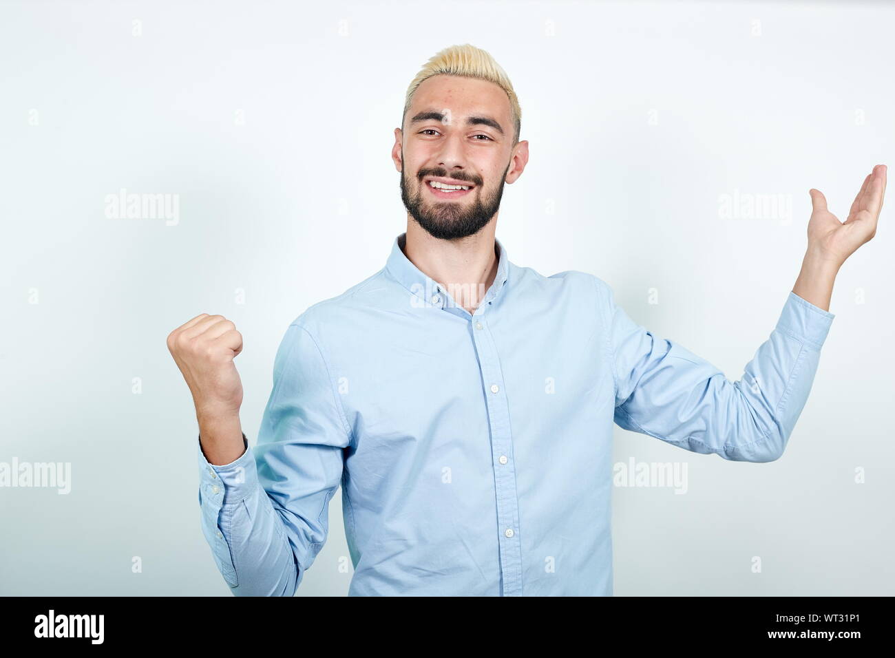 man with blond hair, black beard over isolated white background shows emotions Stock Photo
