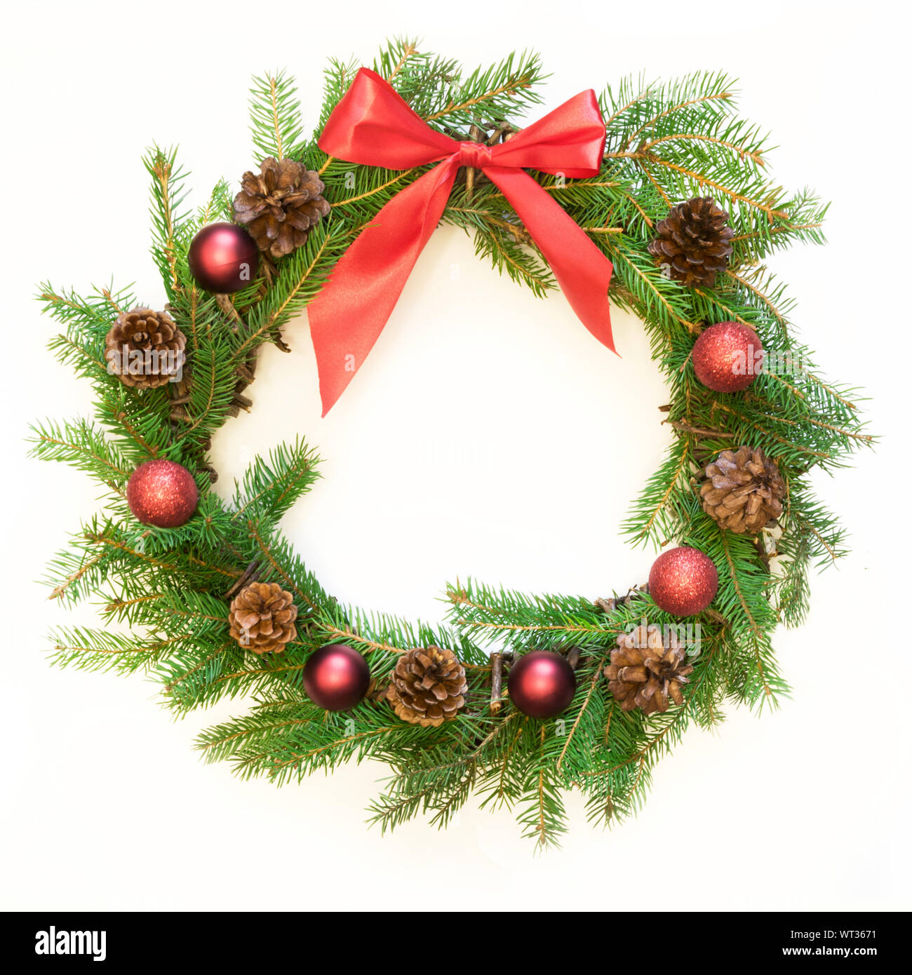 Christmas fresh natural wreath from spruce branch with red bow on white