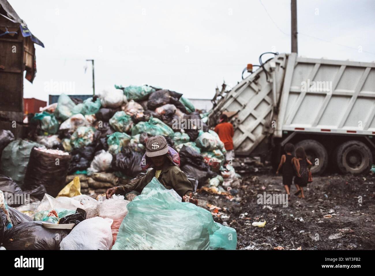 Homeless People Searching In Garbage Heap Stock Photo Alamy