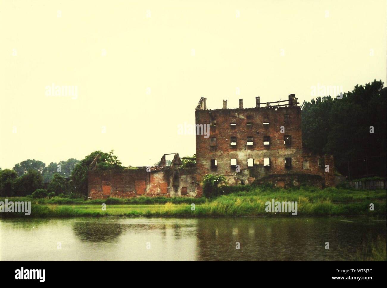 Ruined Buildings On Riverbank Stock Photo