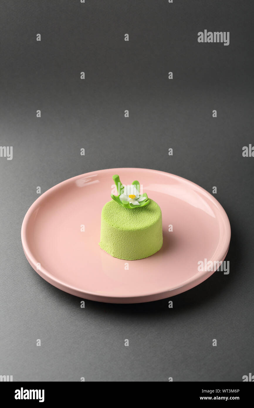 Green spring mini cake close-up on plate, dessert Stock Photo