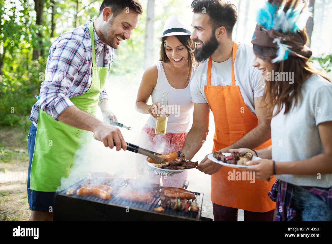 Group of friends having a barbecue party in nature Stock Photo - Alamy