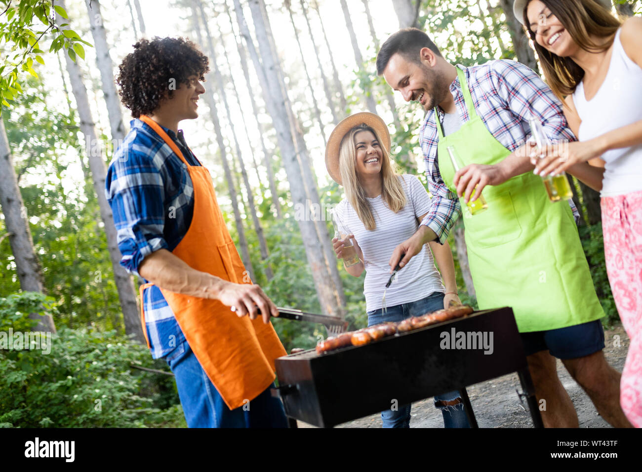 Group of happy friends having a barbecue party in nature Stock Photo ...