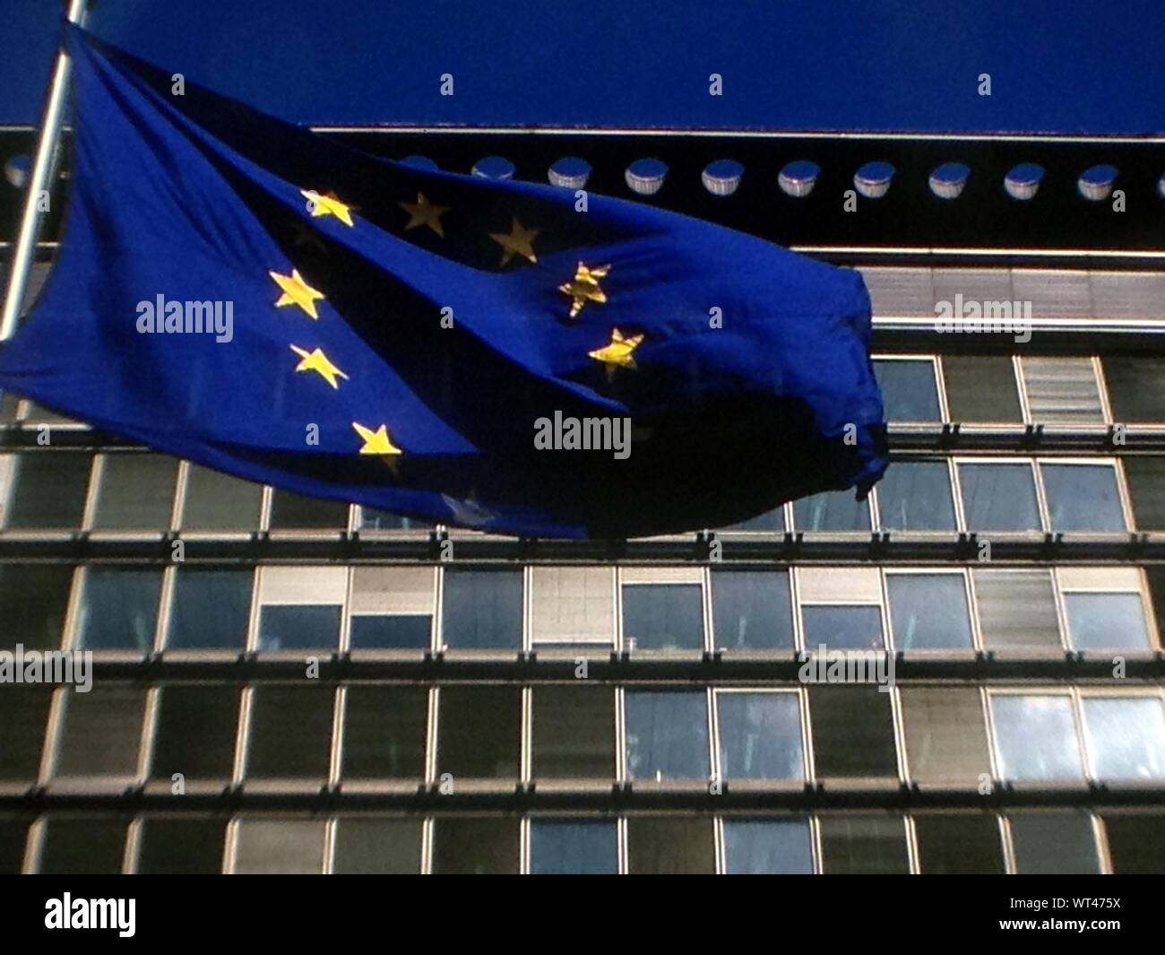 Low Angle View Of European Union Flag Against Eec Building Stock Photo