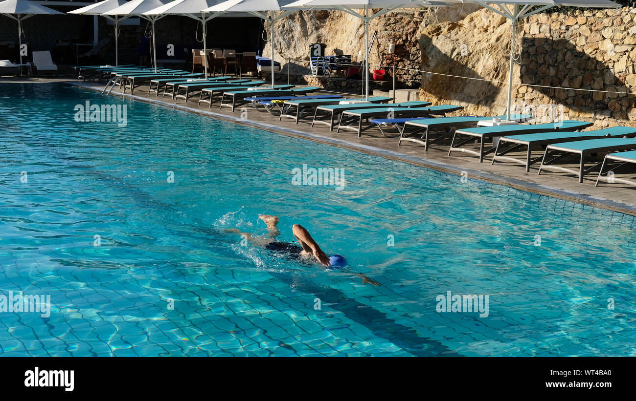 The first swimmer of the day in a hotel swimming pool Stock Photo