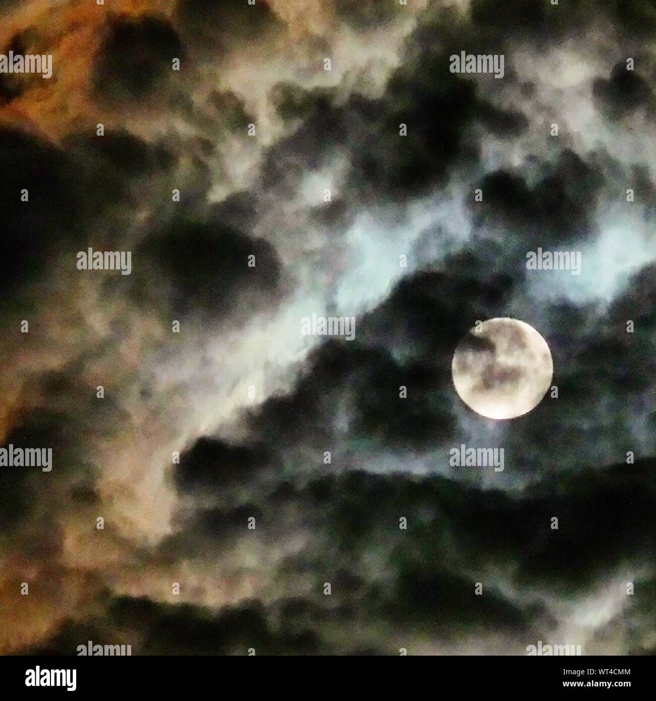 Moon Behind Clouds Stock Photo Alamy