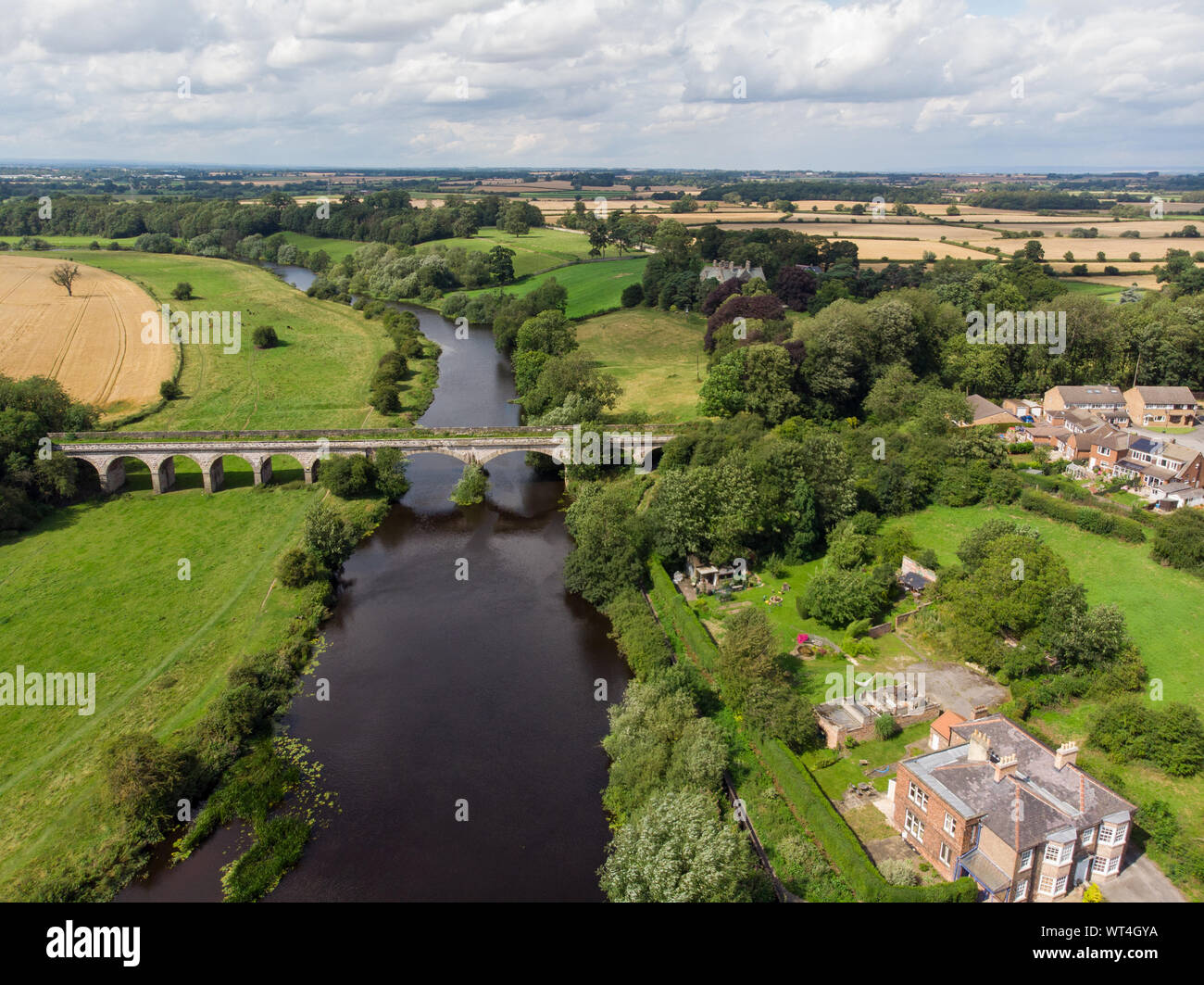 Aerial photo of the the historic Tadcaster Viaduct and River Wharfe located in the West Yorkshire British town of Tadcaster, taken on a bright sunny d Stock Photo