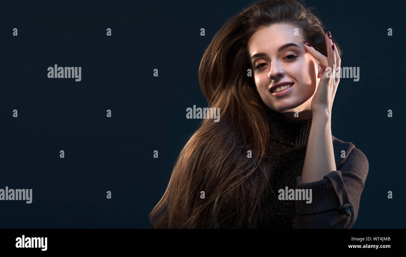 Close-up portrait of charming young thinking woman in black dress ...
