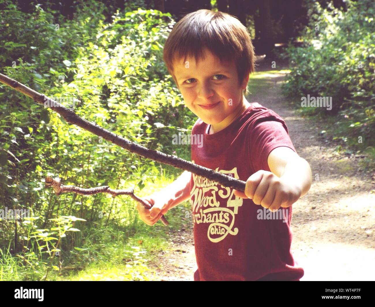 Boys holding sticks hires stock photography and images Alamy