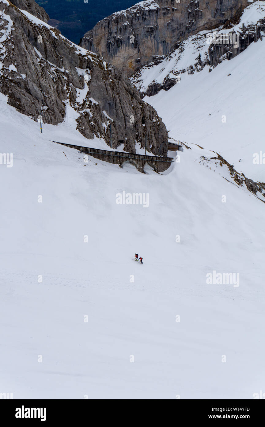 Two hikers trekking through the snow up Mount Pilatus near Lucern in the  Alps in Switzerland Stock Photo - Alamy