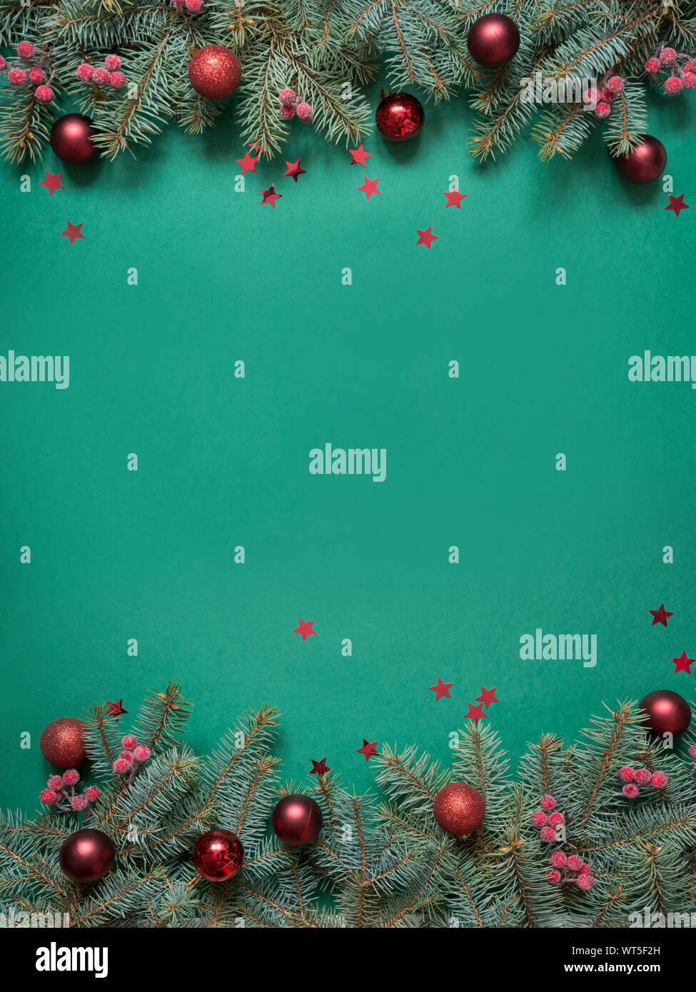 Christmas tree branches, red glass balls on green with copy space. Top ...