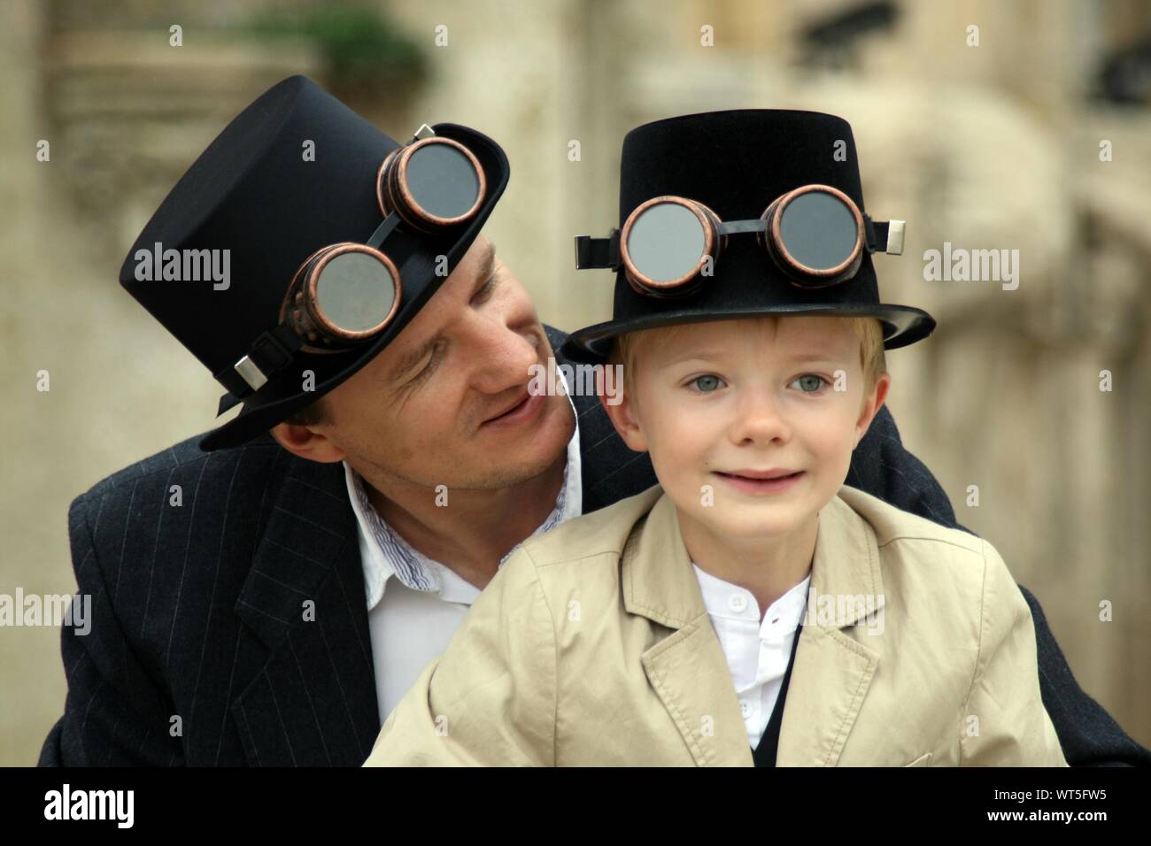 Man With Son Wearing Oldfashioned Goggles On Hat Stock Photo Alamy