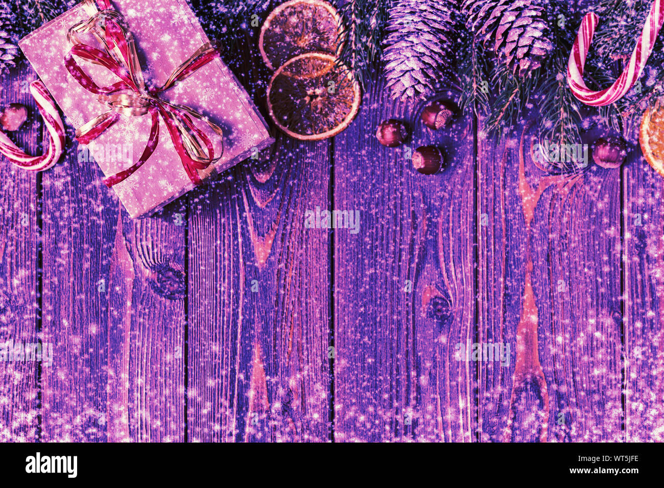Christmas gift boxes and fir tree on wooden background. Top view with ...