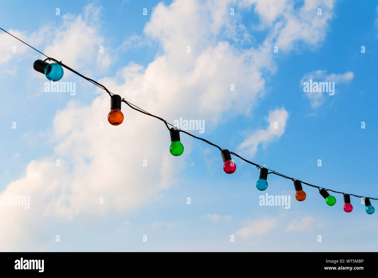 Colorfull lightbulbs against blue sky Stock Photo