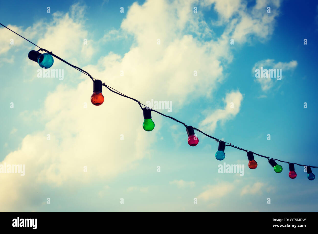 Colorfull lightbulbs against blue sky Stock Photo