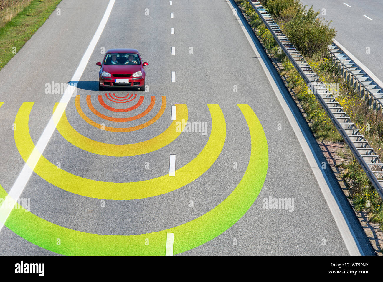 Sensors monitor the traffic in a modern car on a fast road... Stock Photo