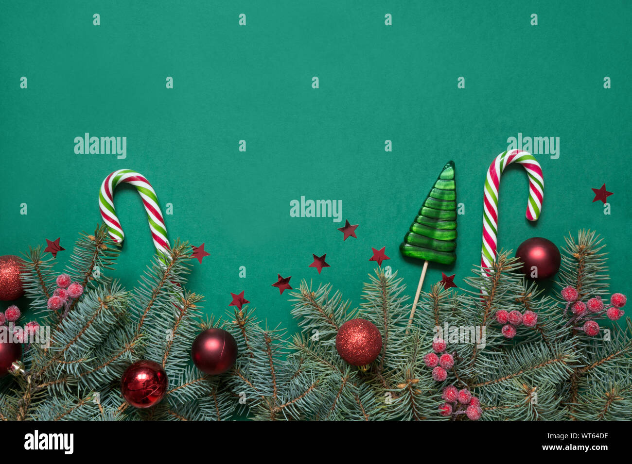 Christmas tree branches, red glass balls on green with copy space. Top ...