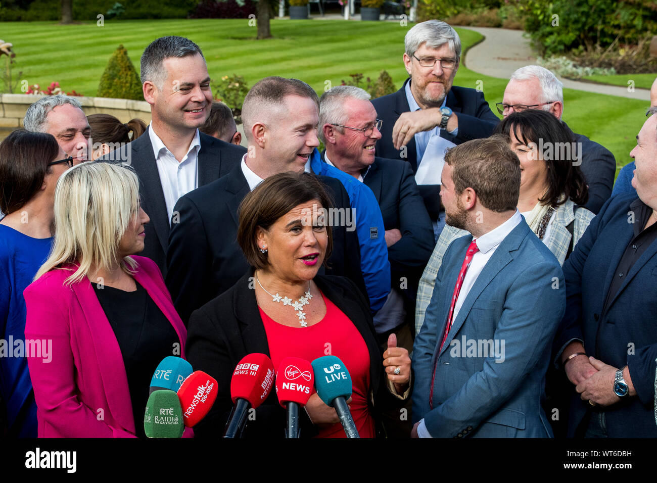 Sinn Fein president Mary Lou McDonald motions to party colleague John O'Dowd (rear of crowd with hand motioning) during a doorstep with media before a party meeting at the Carrickdale Hotel and Spa in Dundalk. Stock Photo