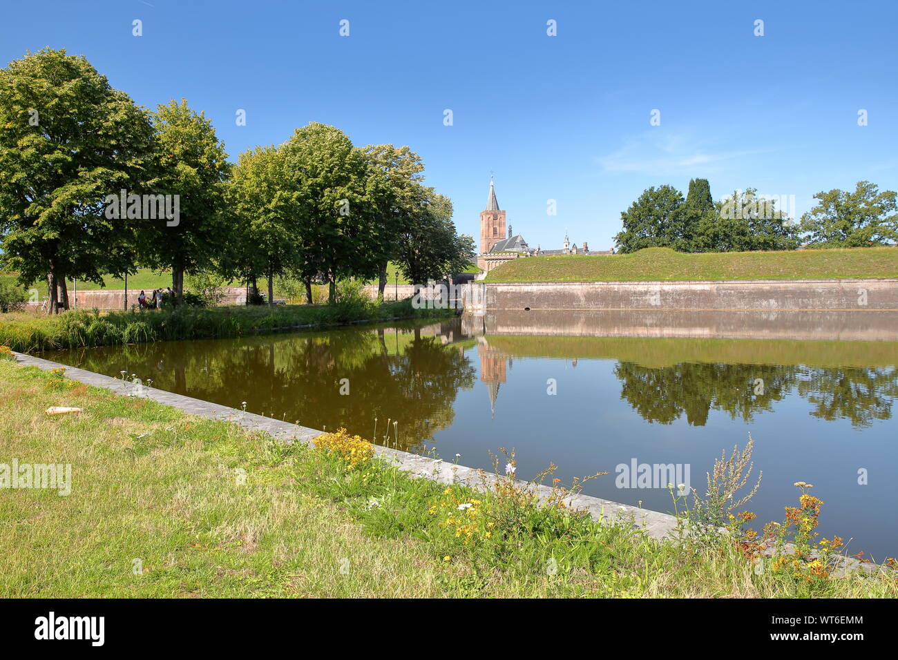 The fortifications and moats of the city of Naarden, Netherlands, with the Grote Kerk church in the background Stock Photo