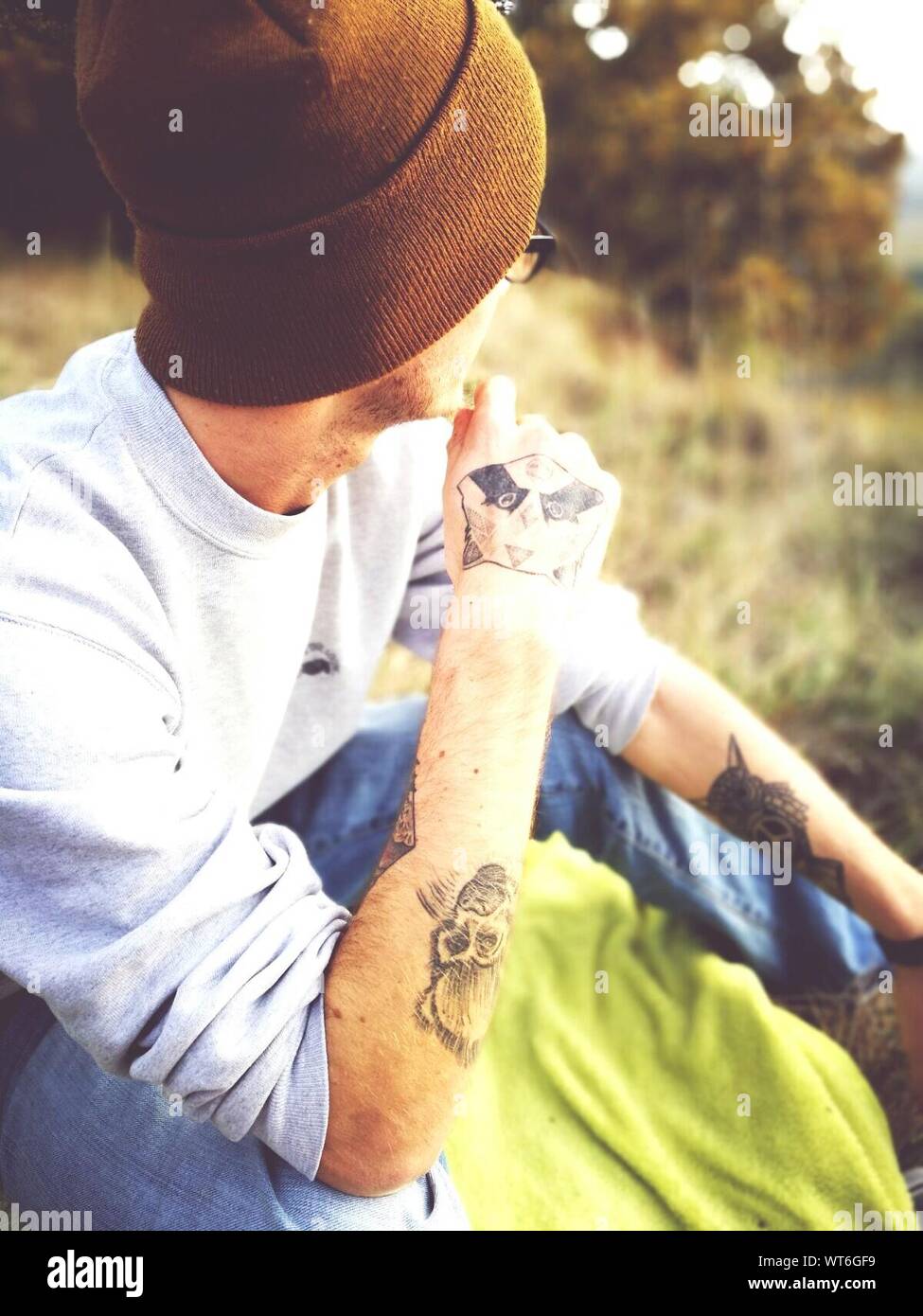 Man tattoos sitting hi-res stock photography and images - Alamy