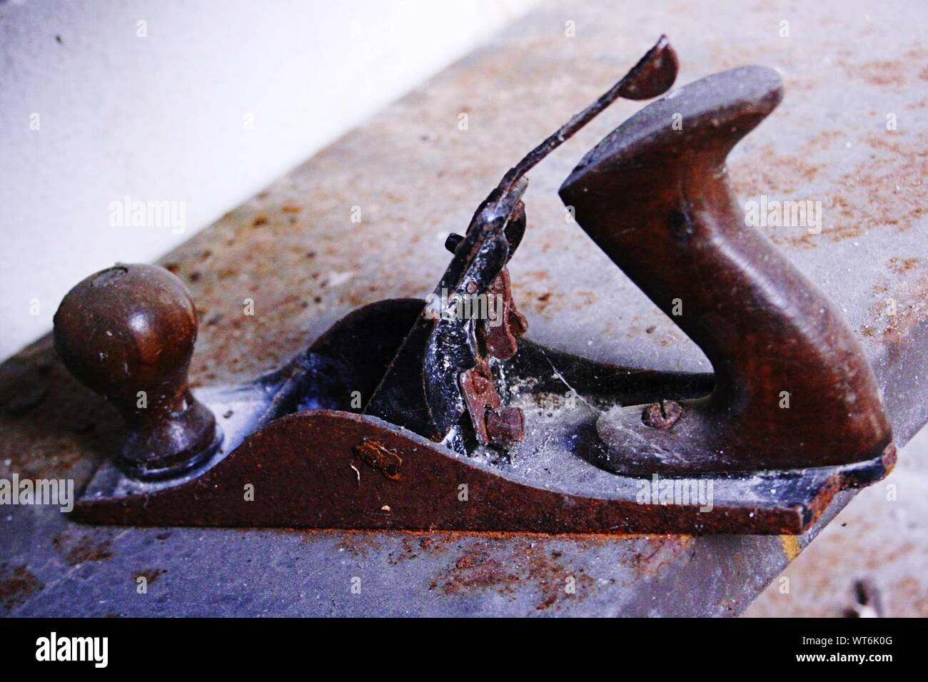 Close-up Of Rusty Smoothing Plane On Table Stock Photo