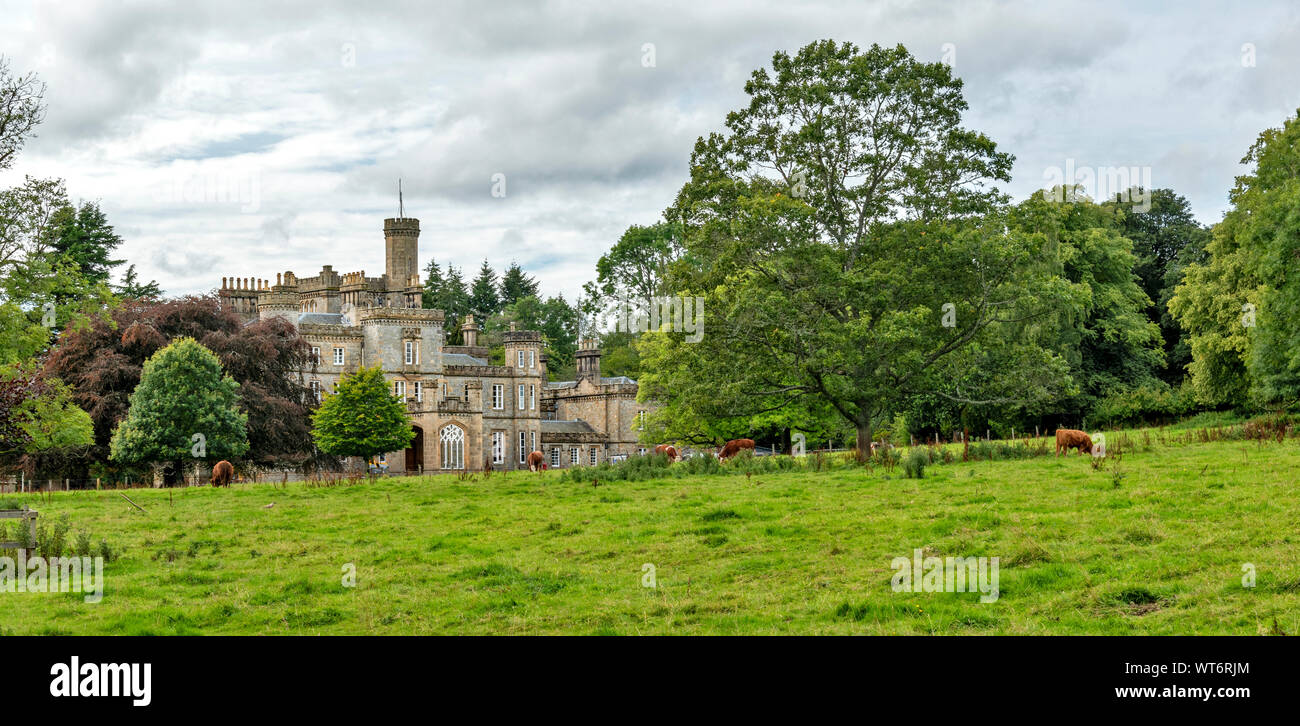 DRUMMUIR CASTLE MORAY SCOTLAND THE BUILDING AND FIELD WITH CATTLE Stock Photo