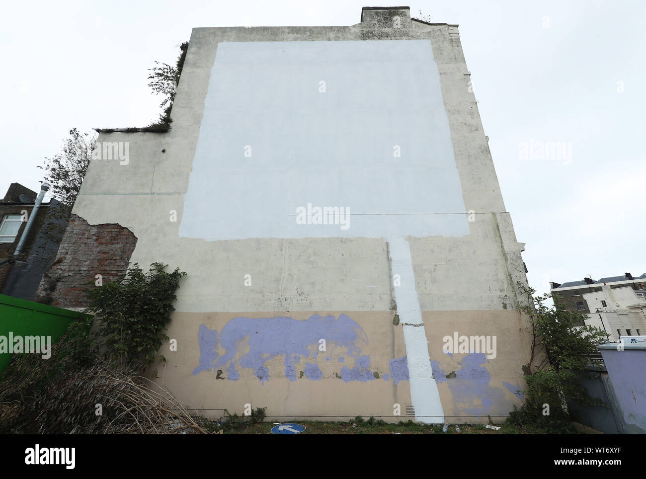 A Brexit-themed Banksy mural in Dover that has been mysteriously covered up with white paint. The artwork appeared on a former amusements arcade near Dover's busy ferry terminal in May 2017 and showed an EU flag with a workman chipping away one of the stars. Stock Photo