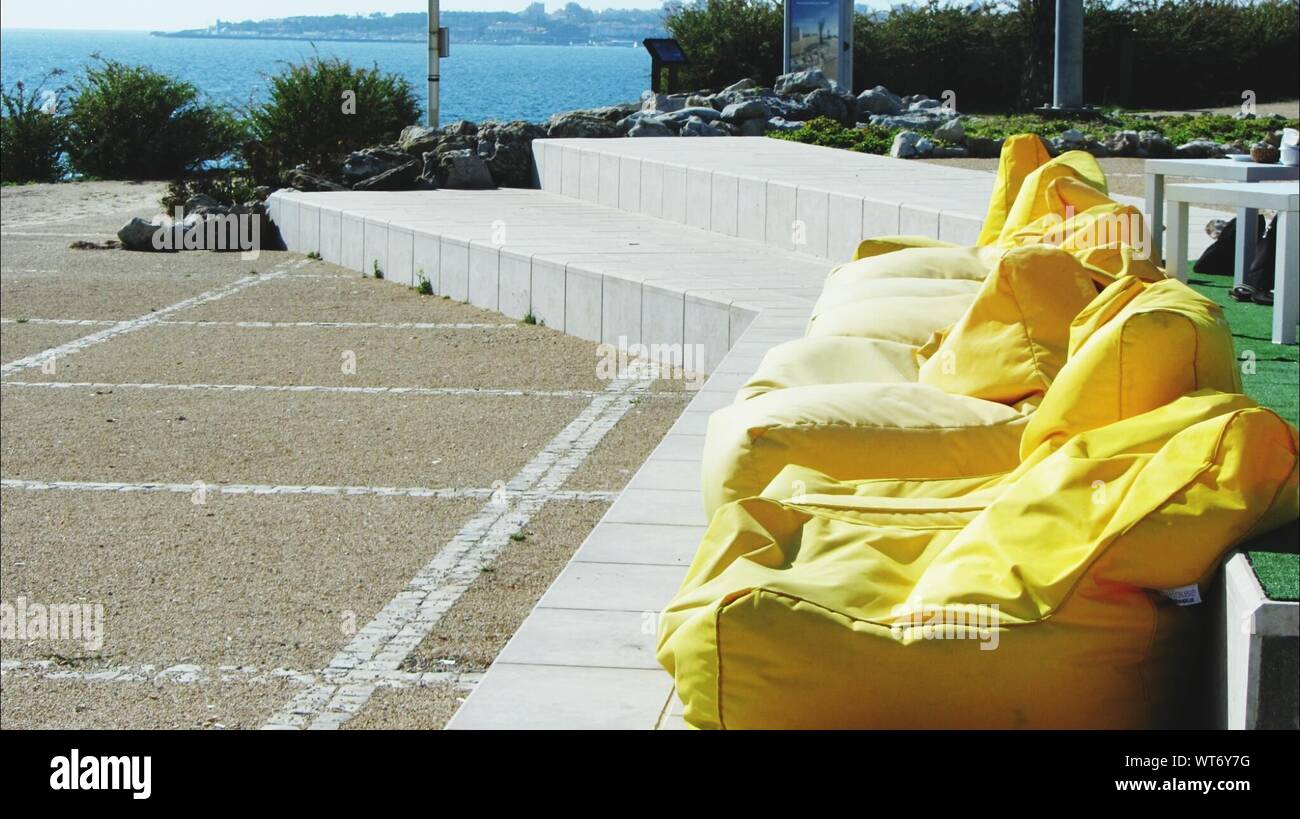 Yellow Bean Bags In Row On Terrace Stock Photo