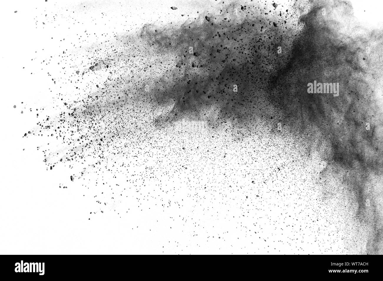 Black powder explosion. The particles of charcoal splatter on white
