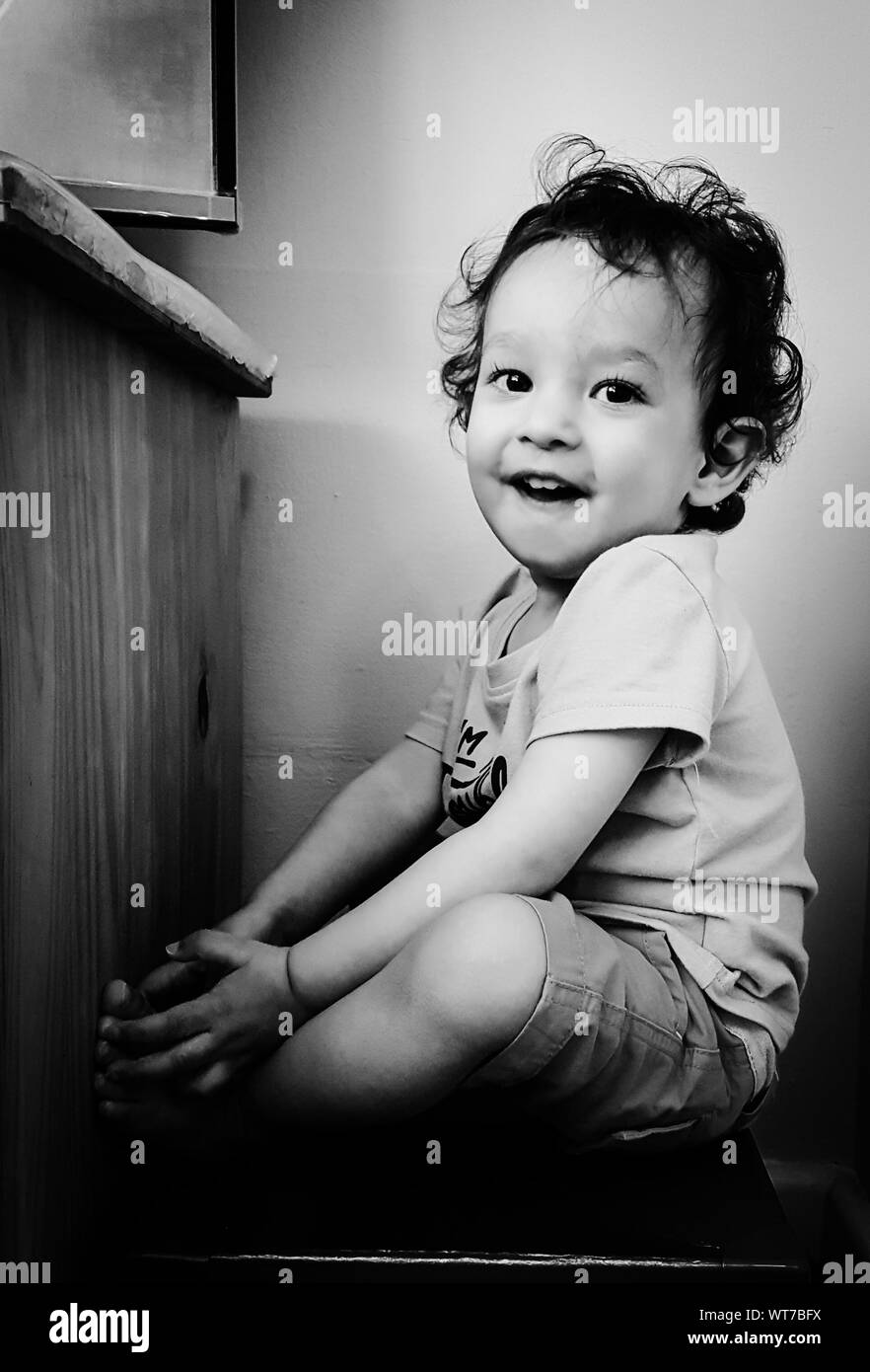 Boy sitting on stool hi-res stock photography and images - Alamy