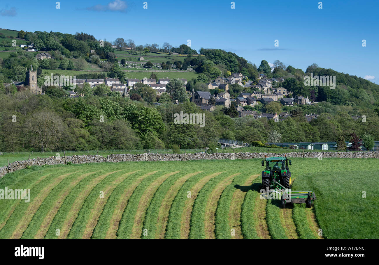Mowing grass in a meadow with a John Deere 6130 tractor and a John Deere 1355 Mower conditioner. Pateley Bridge, North Yorkshire, UK. Stock Photo