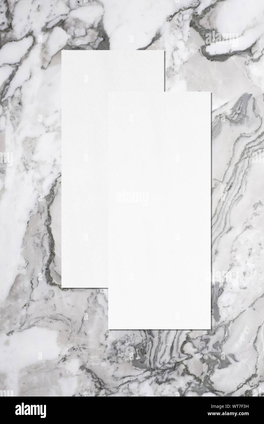 Two empty price-list or menu mockups with soft shadows, lying on top of  each other on grey marble background. Flat lay, top view Stock Photo - Alamy
