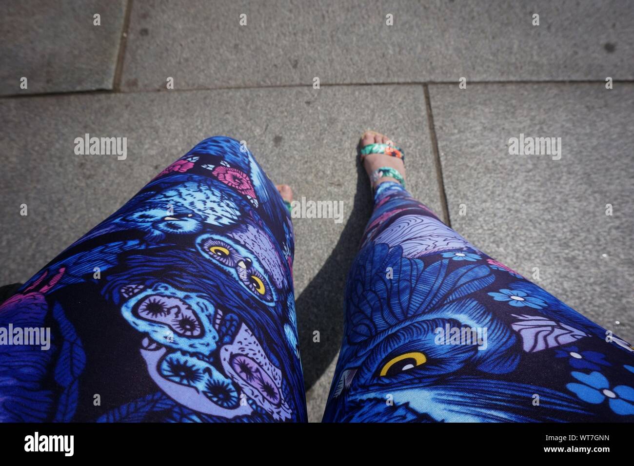 Low Section Of Woman Wearing Blue Leggings Stock Photo