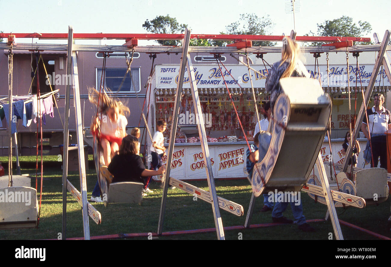 1990s, children outside on a swing at a funfair, England, UK. Stock Photo