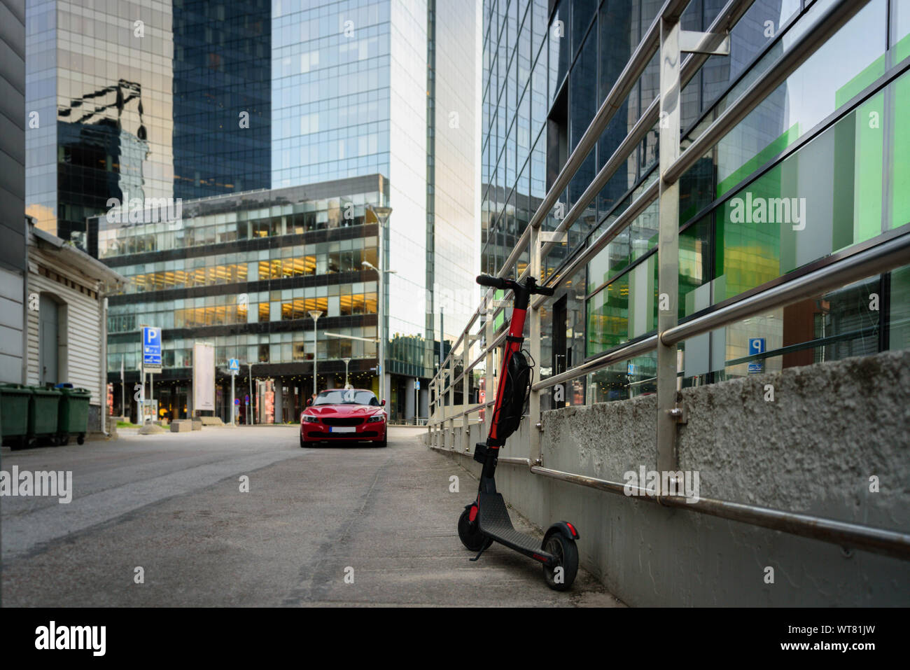 Electric kick scooter in modern city district with skyscrapers. Sharing ...
