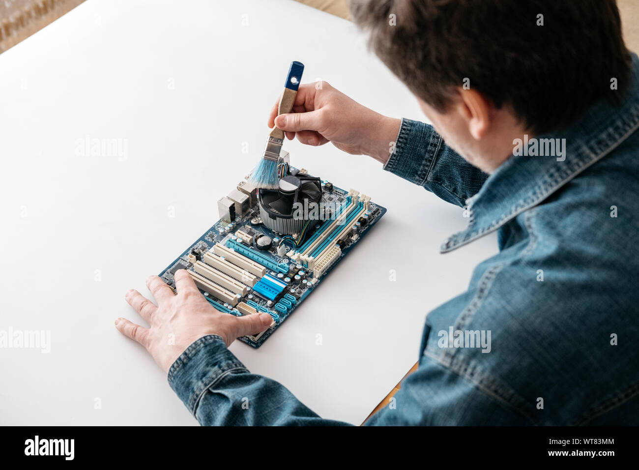 Technician using brush for computer cleaning, clean the