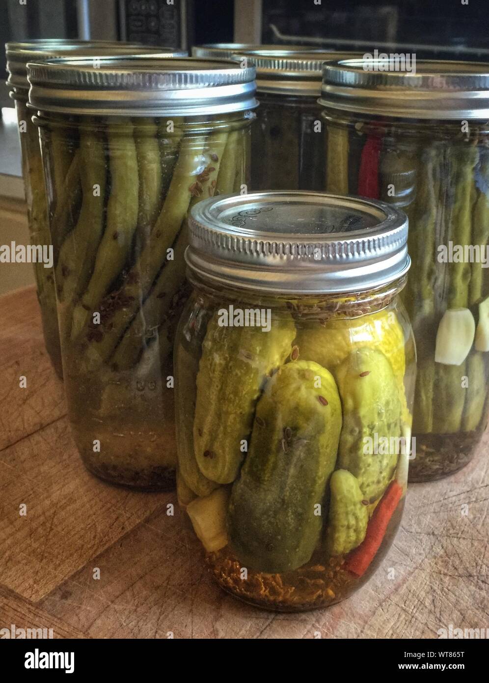 Pickles In Glass Jars On Table At Home Stock Photo