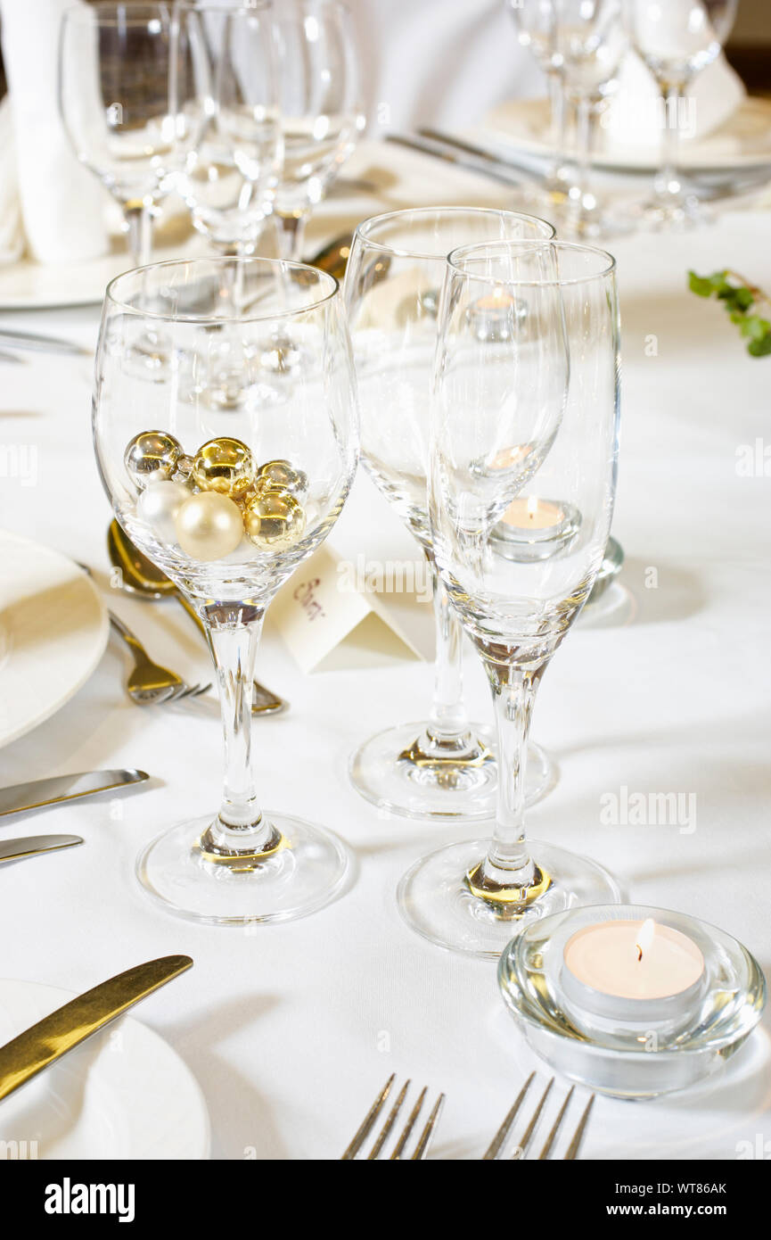 Wine glasses and champagne flute at a wedding table place setting Stock Photo